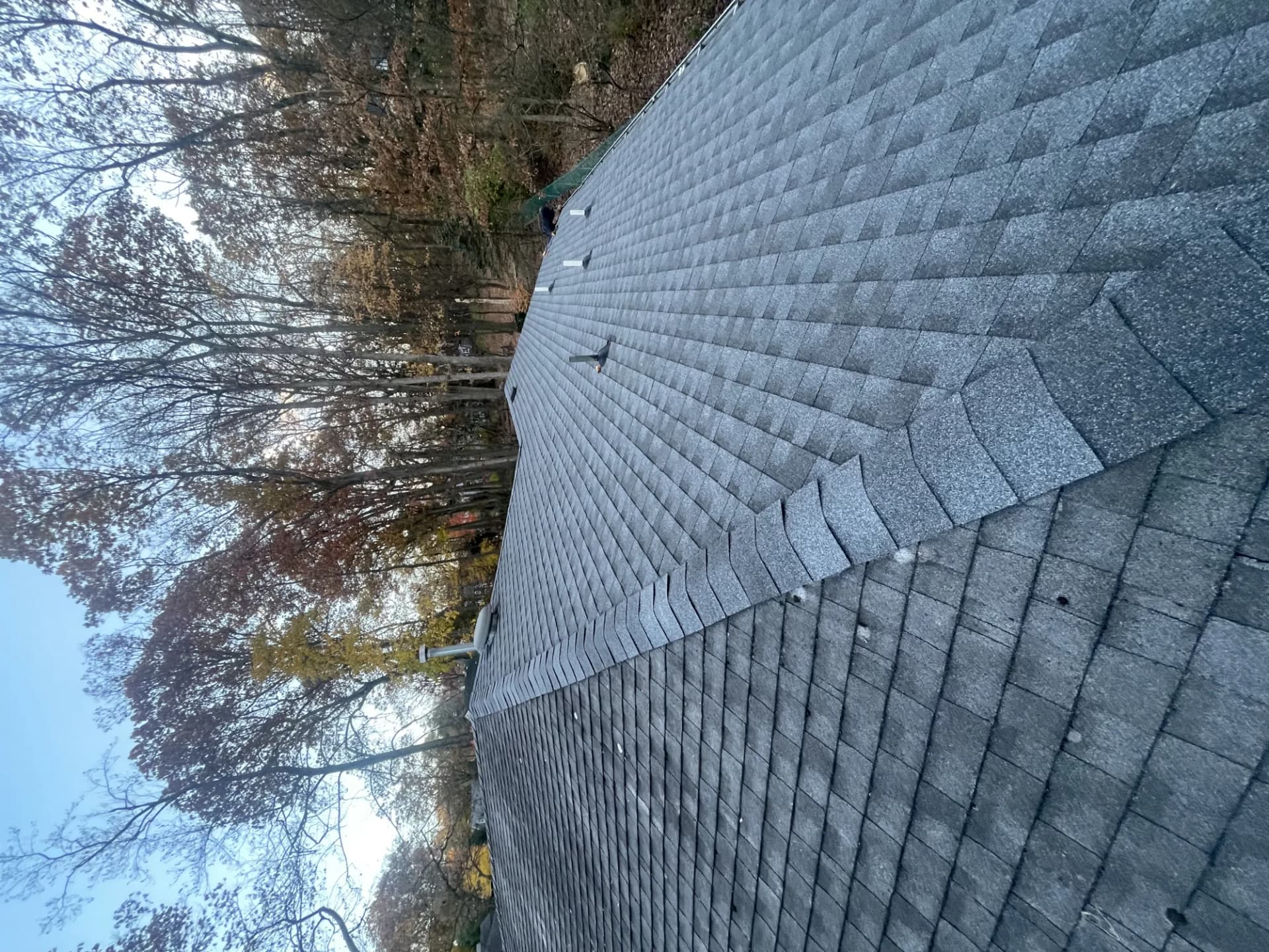 Completed gray asphalt shingle roof with a clean valley by Alpha Pro Construction in New Jersey