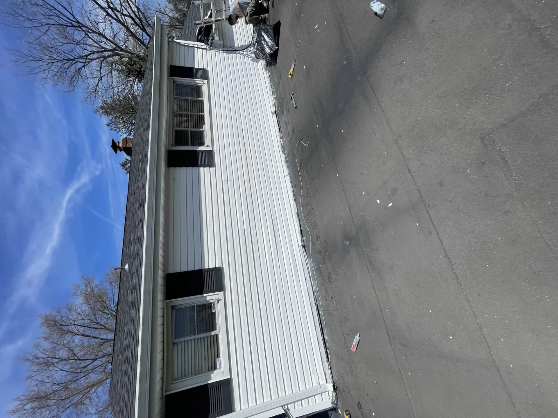 Newly installed white standing seam metal roof on a manufactured home in New Jersey